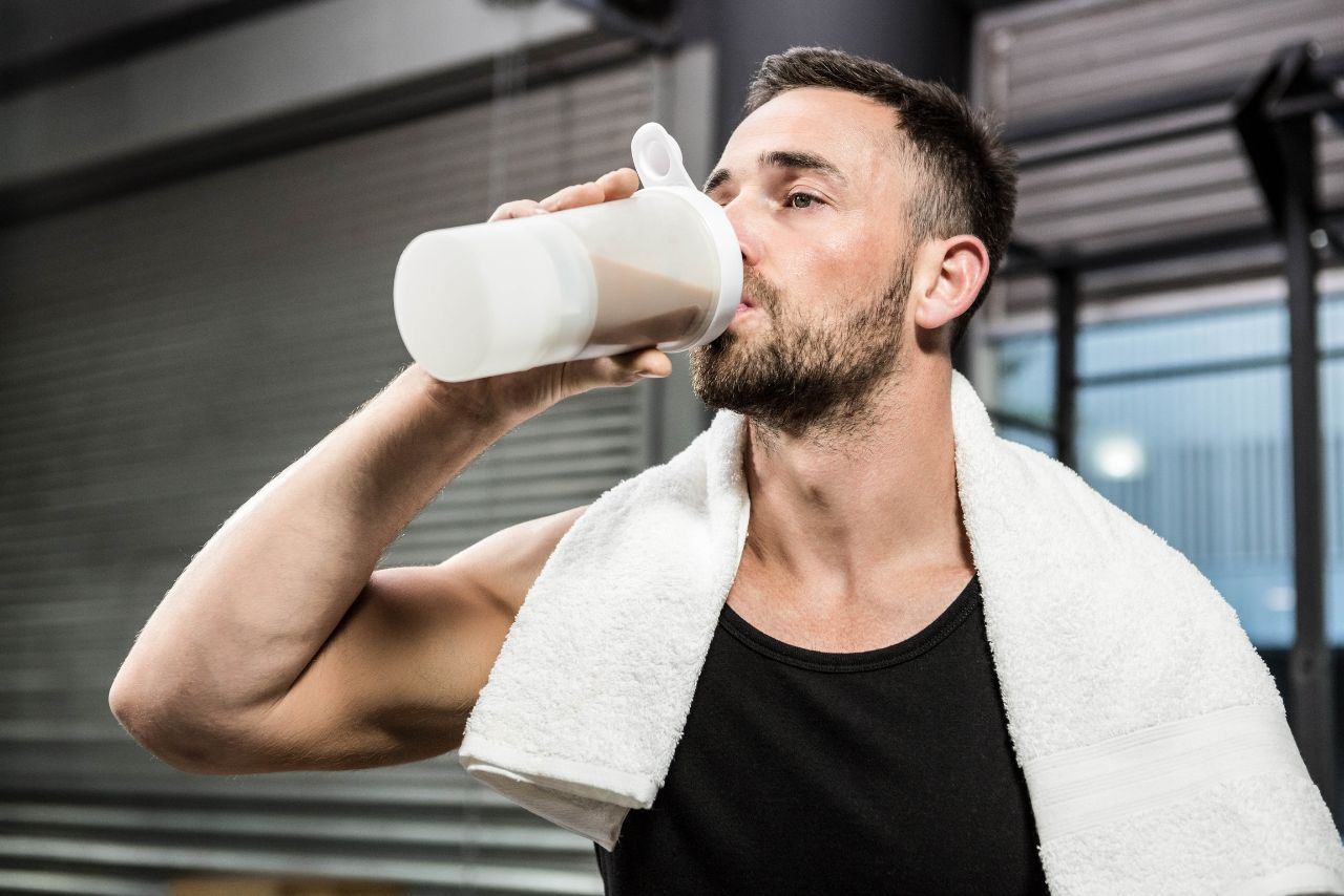 man Drinking whey Protien shake during gym hours